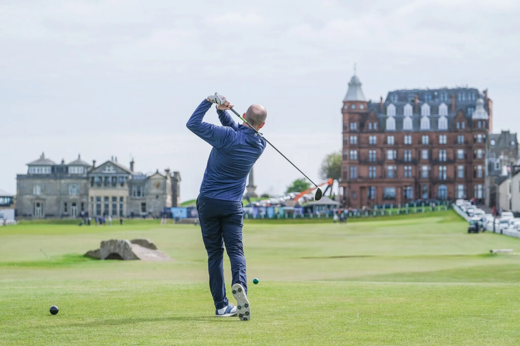 An H&B Member hits tee shot at The Old Course during St. Andrews golf trip