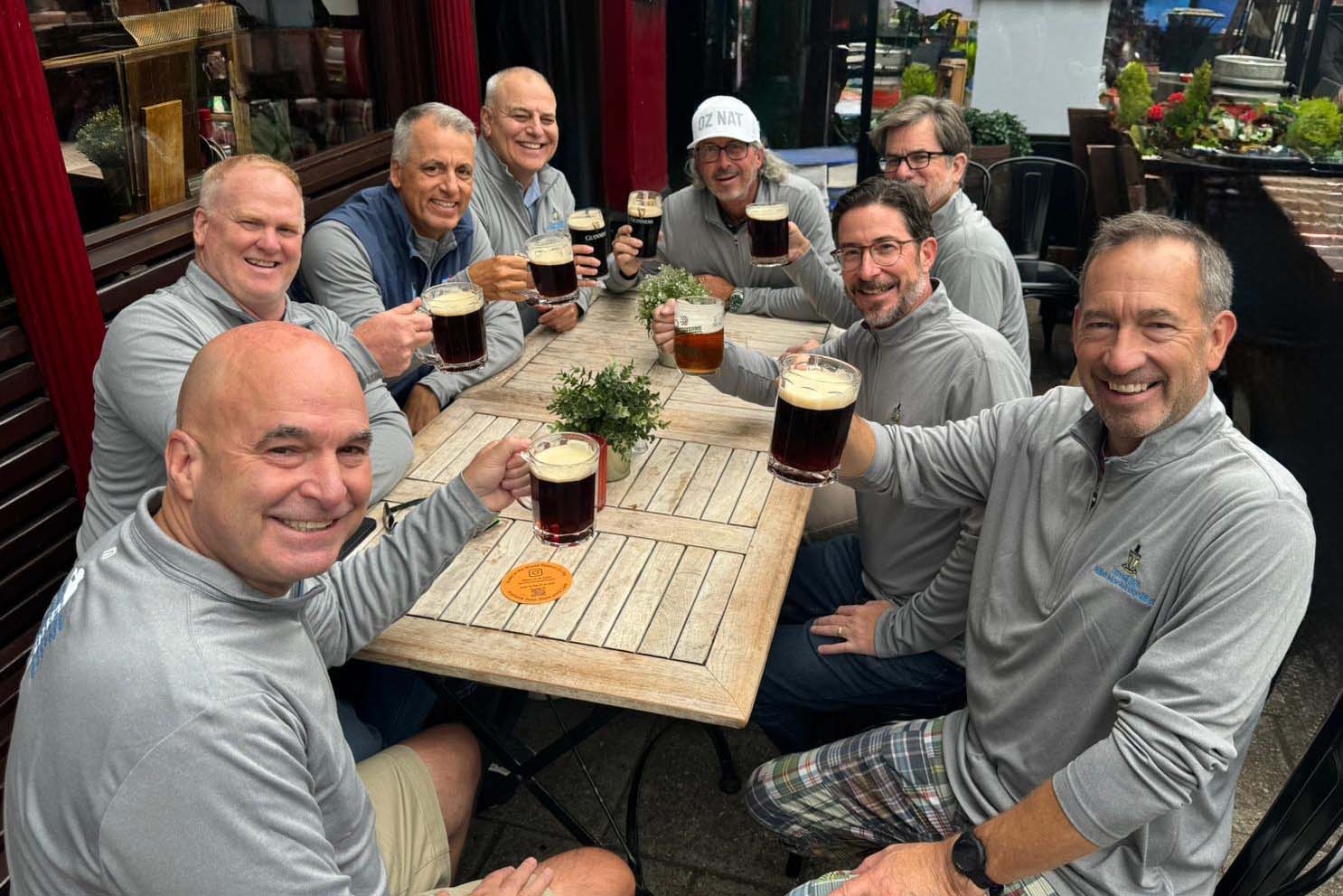 first-day-tips-golf-trips Golfers enjoying toast on first day of golf trip