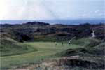 Pyle & Kenfig Golf Club We are tempted to proclaim the club's backside as the best in all of Wales, but having seen Zeta-Jones in Chicago, we clarify that P&K boasts best backside in Welsh golf. The original course, laid out in 1922 by the legendary Harry Colt, required extensive modification after military authorities requisitioned a sizeable portion of the links during WWII. Enter Philip Mackenzie Ross who, through his work here and at the Ailsa course at Turnberry, demonstrated a marvelous ability to overcome the ravages of the British military. His final nine meander about splendid sand dunes clad in tall ferns, to form an experience most pleasing to both the senses and shot making of the visiting golfer. 