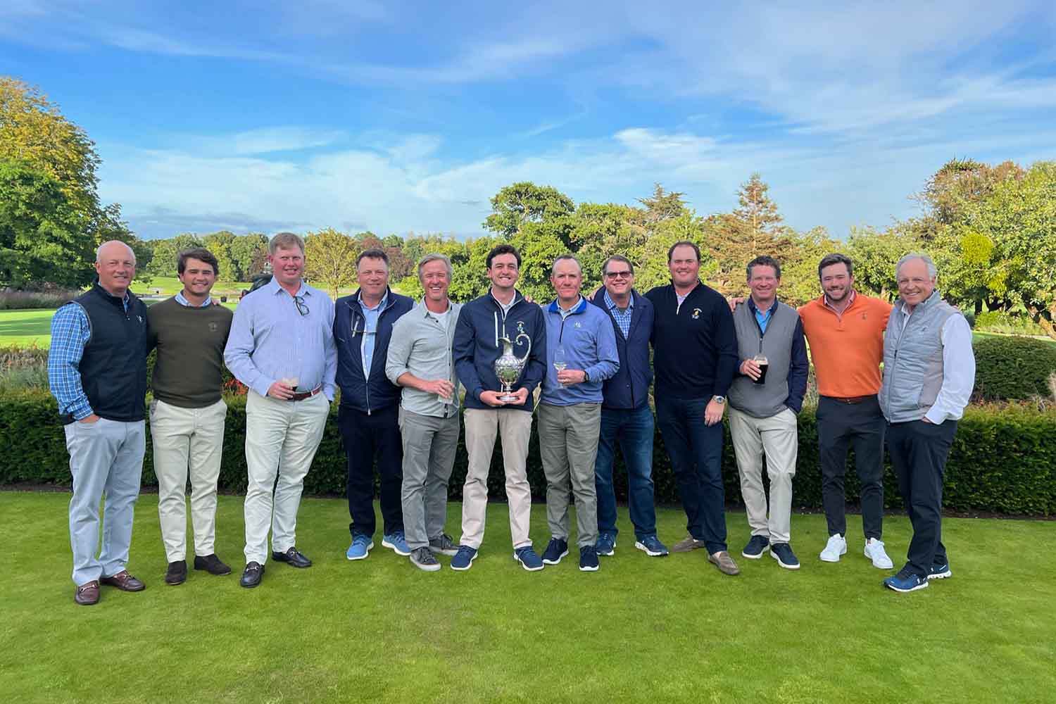 Golfers in Ireland with trophy.